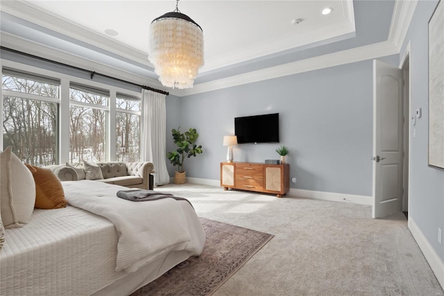 bedroom with baseboards, a tray ceiling, and crown molding