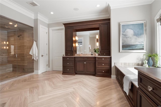 bathroom featuring vanity, baseboards, visible vents, a stall shower, and crown molding