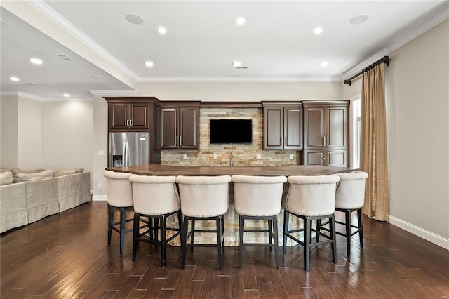 kitchen featuring a kitchen breakfast bar, a kitchen island, and stainless steel fridge with ice dispenser