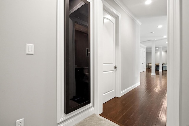 hallway with dark wood-style floors, crown molding, recessed lighting, and baseboards