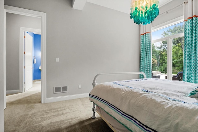 bedroom featuring light colored carpet, visible vents, and baseboards