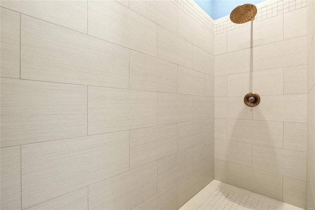 bathroom with a skylight and a tile shower