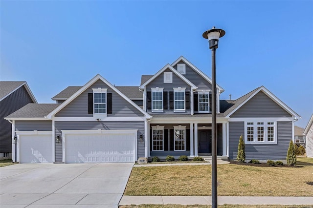 traditional-style house with a front lawn, concrete driveway, and an attached garage