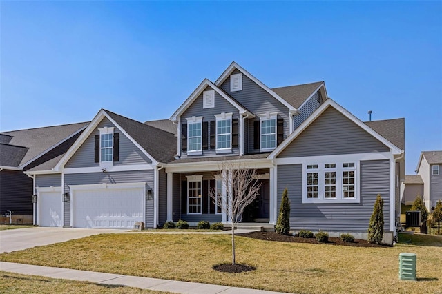 traditional-style home with a front yard, driveway, a porch, central AC, and a garage