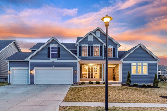 traditional-style house with a yard and driveway