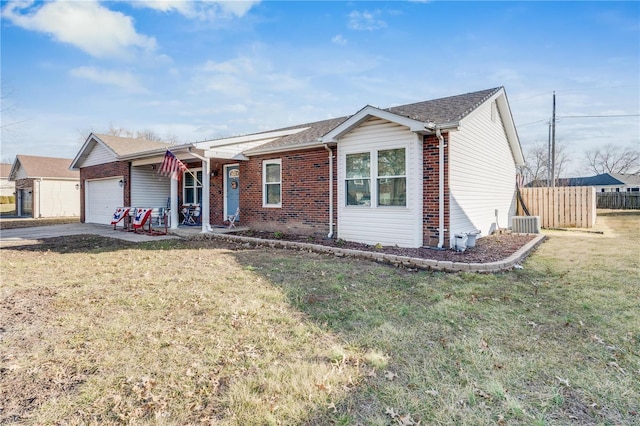 ranch-style home featuring a garage, brick siding, concrete driveway, fence, and a front yard