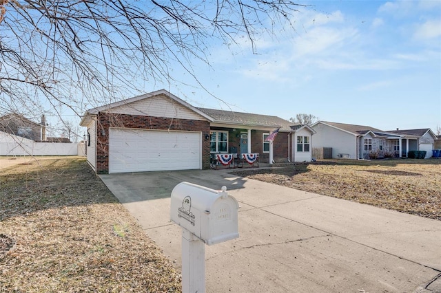 ranch-style home featuring an attached garage, concrete driveway, and brick siding