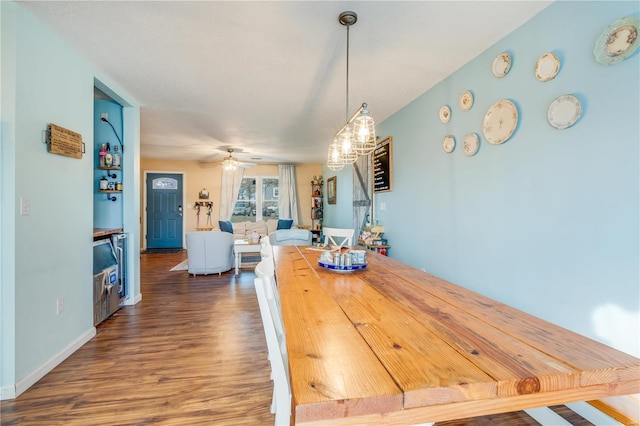 dining area featuring ceiling fan, baseboards, and wood finished floors