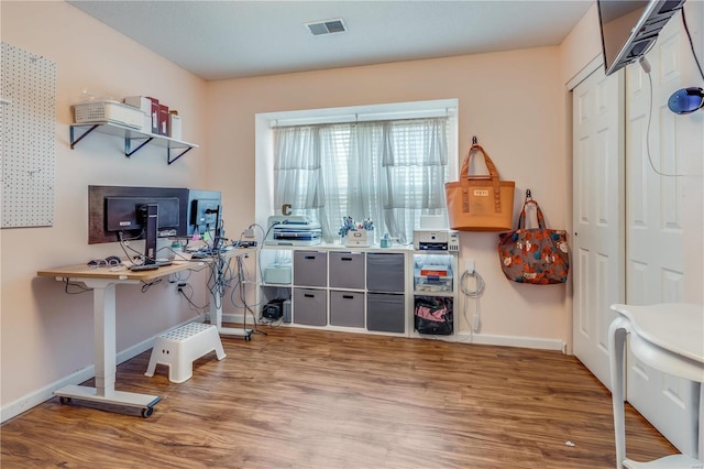 office with visible vents, baseboards, and wood finished floors