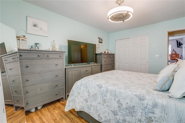 bedroom featuring a closet and light wood-style flooring