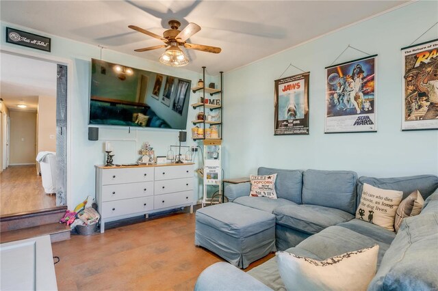 living room with ornamental molding, ceiling fan, and wood finished floors