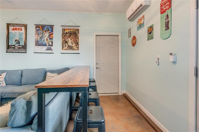 living room featuring baseboards and an AC wall unit