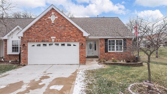 view of front facade with brick siding, a shingled roof, a garage, driveway, and a front lawn