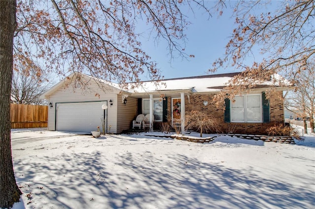 ranch-style home featuring brick siding, a garage, and fence