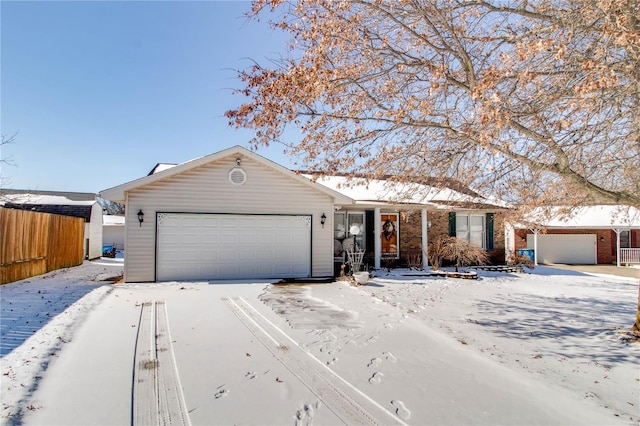 ranch-style house with fence, brick siding, and a garage