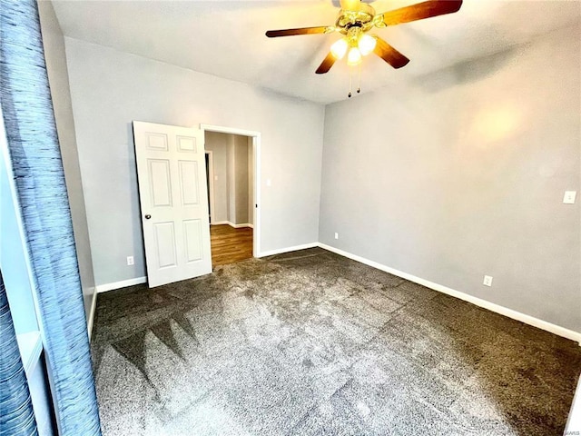 unfurnished bedroom featuring ceiling fan, carpet, and baseboards