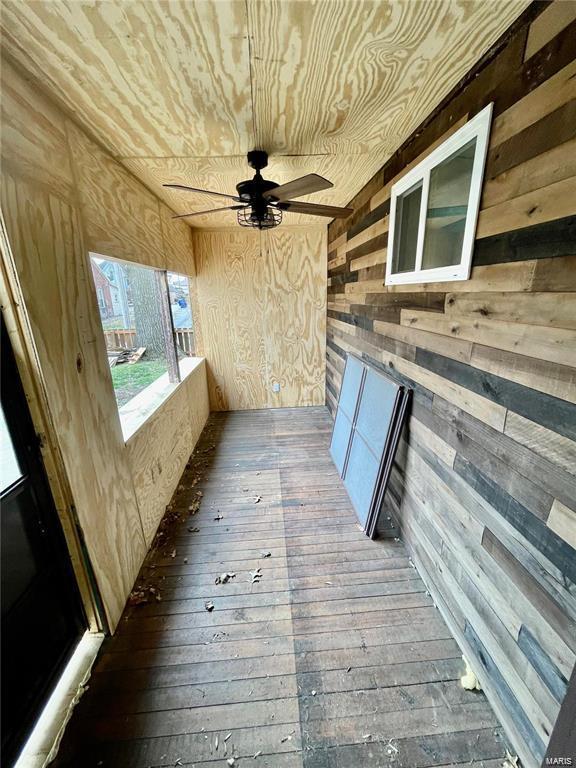 interior space with ceiling fan and wood ceiling