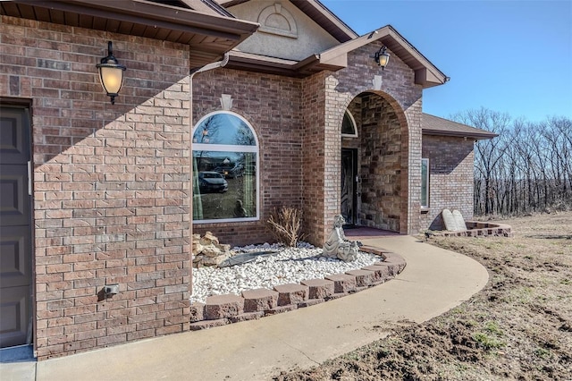 entrance to property featuring brick siding