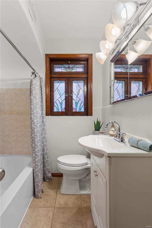 full bathroom featuring toilet, visible vents, vanity, tile patterned floors, and shower / bath combo with shower curtain