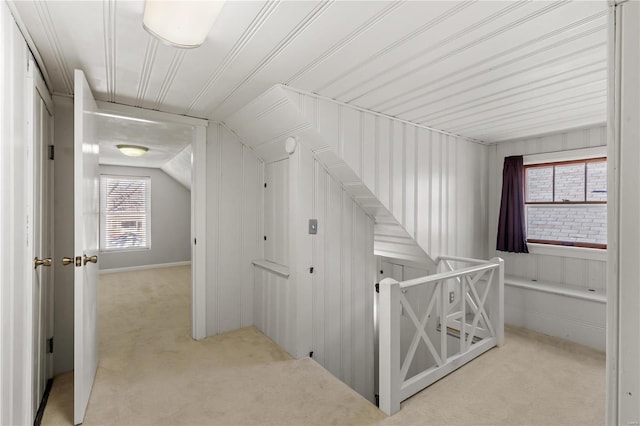 interior space featuring light carpet and vaulted ceiling