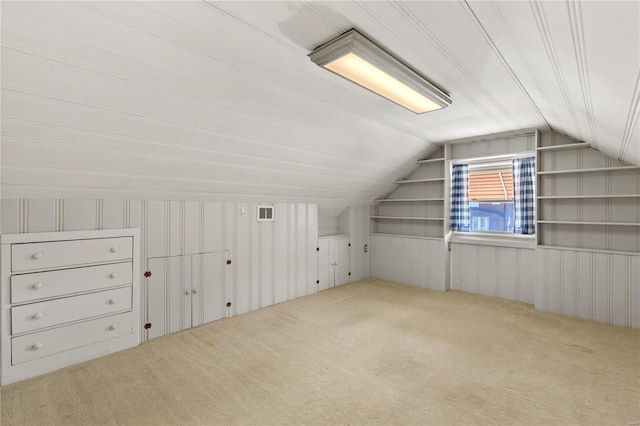 additional living space with lofted ceiling, carpet flooring, and visible vents