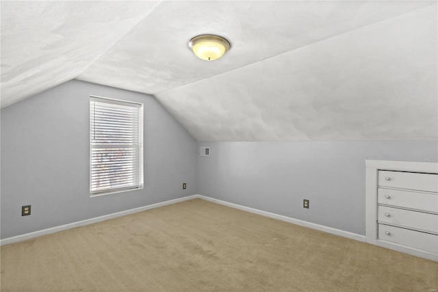 bonus room featuring light carpet, vaulted ceiling, visible vents, and baseboards