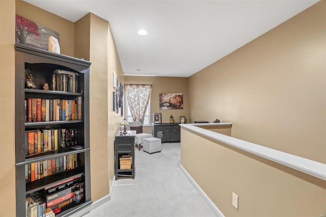 corridor with carpet flooring, an upstairs landing, and baseboards