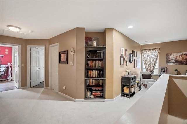 hallway with carpet, baseboards, and built in features