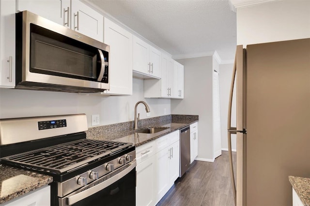 kitchen featuring a sink, appliances with stainless steel finishes, ornamental molding, and white cabinets