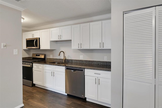 kitchen with crown molding, appliances with stainless steel finishes, dark wood-style floors, a textured ceiling, and a sink