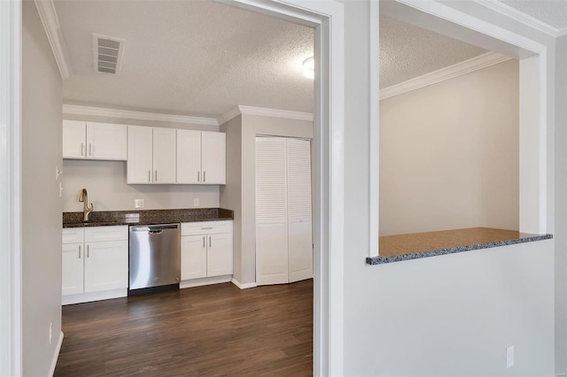 kitchen with visible vents, stainless steel dishwasher, ornamental molding, and dark wood finished floors