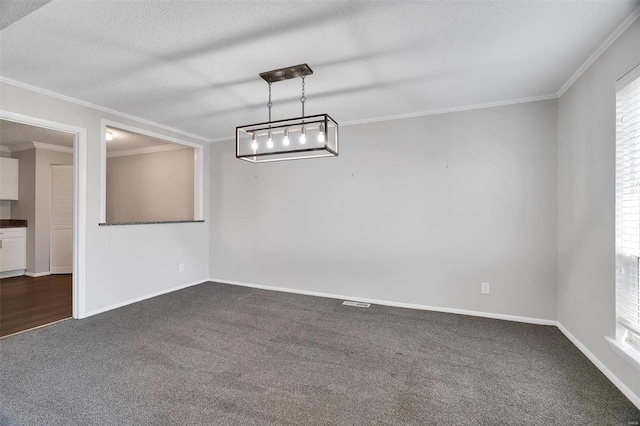 unfurnished dining area with dark colored carpet, a textured ceiling, and ornamental molding