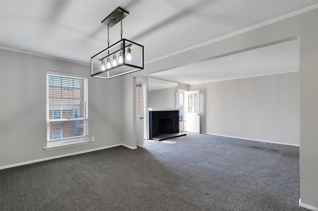 unfurnished living room featuring dark carpet, a brick fireplace, and crown molding