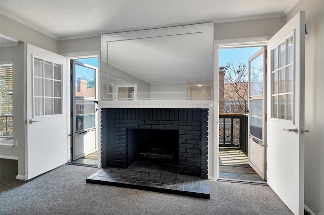 unfurnished living room featuring a brick fireplace, crown molding, and carpet