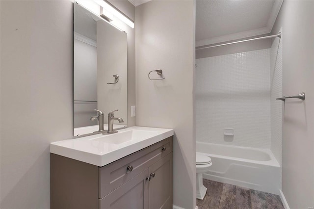 bathroom with vanity, toilet, wood finished floors, and tub / shower combination