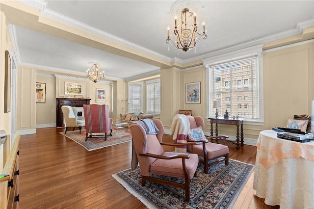 interior space with ornamental molding, a notable chandelier, baseboards, and wood finished floors