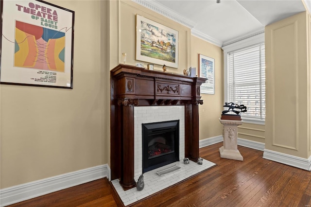 interior space with baseboards, crown molding, wood-type flooring, and a brick fireplace