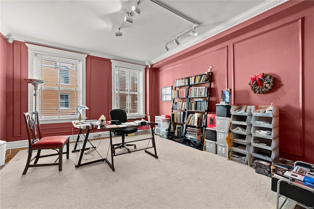 carpeted office with a decorative wall and crown molding