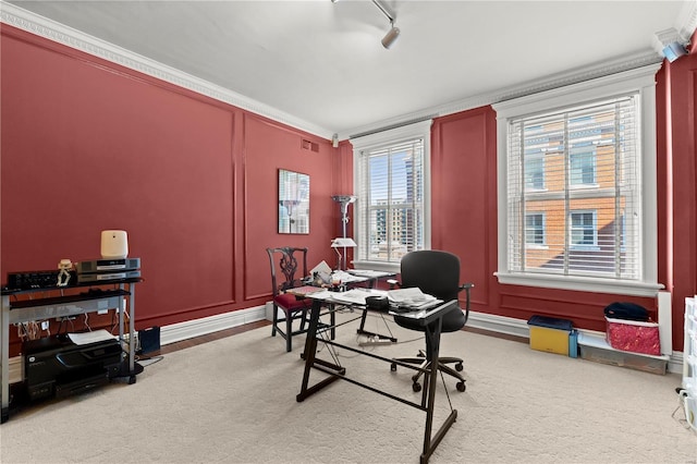 carpeted office featuring visible vents, ornamental molding, rail lighting, and a decorative wall