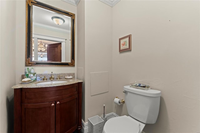 half bathroom featuring toilet, crown molding, and vanity