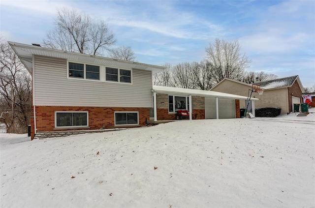 tri-level home with brick siding and an attached garage