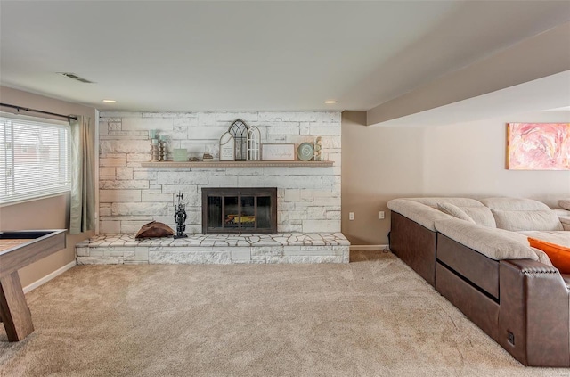 living room with baseboards, a fireplace, visible vents, and light colored carpet