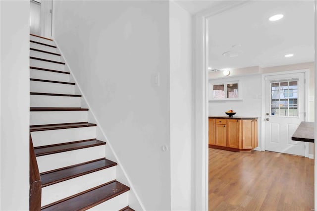 stairway featuring recessed lighting and wood finished floors