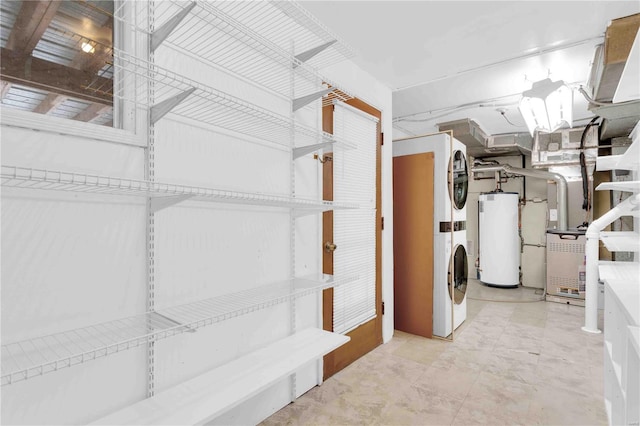 interior space featuring heating unit, water heater, and stacked washing maching and dryer