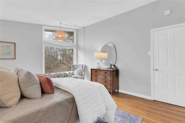 bedroom featuring baseboards and wood finished floors