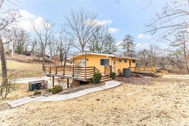 rear view of house featuring a deck and central AC