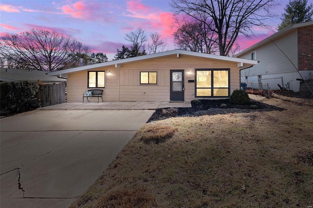 view of front of home featuring fence