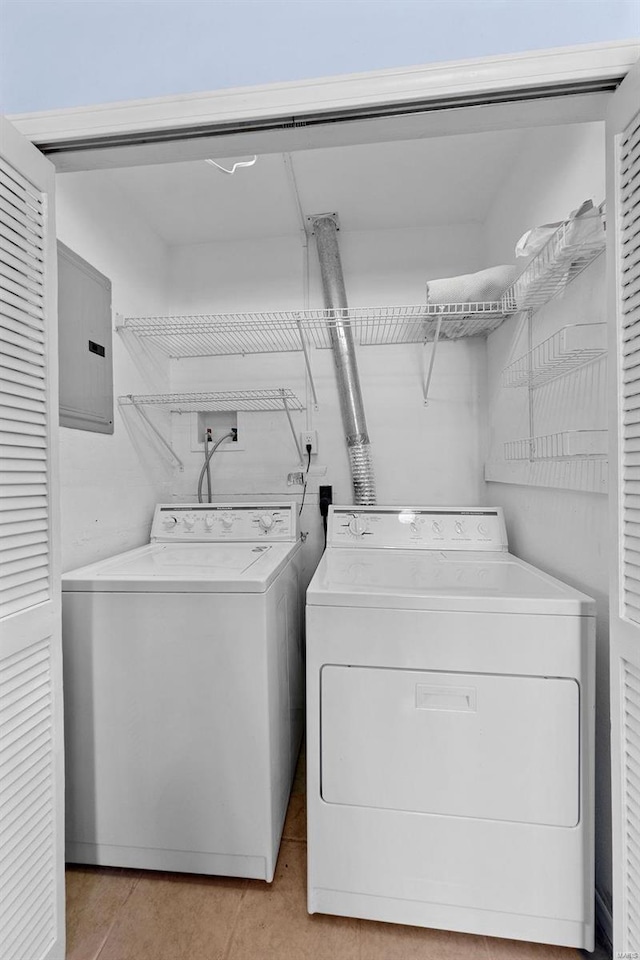 clothes washing area featuring laundry area, washing machine and clothes dryer, and electric panel