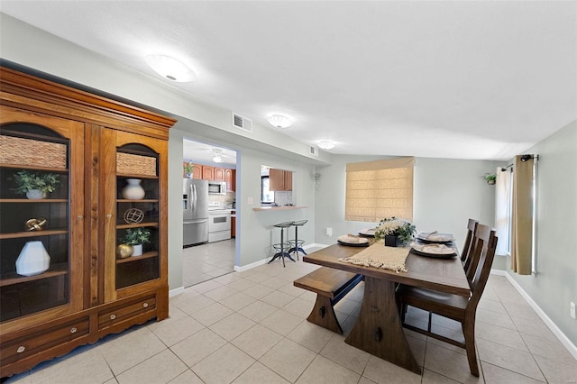 dining room featuring visible vents, baseboards, and light tile patterned floors