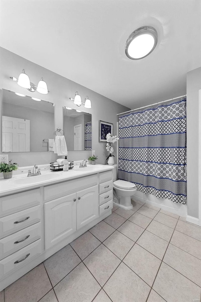 full bath with double vanity, toilet, curtained shower, tile patterned flooring, and a sink